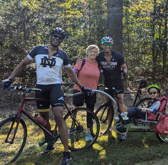A family of riders and a walker gathered on the trail during a past Fall Challenge
