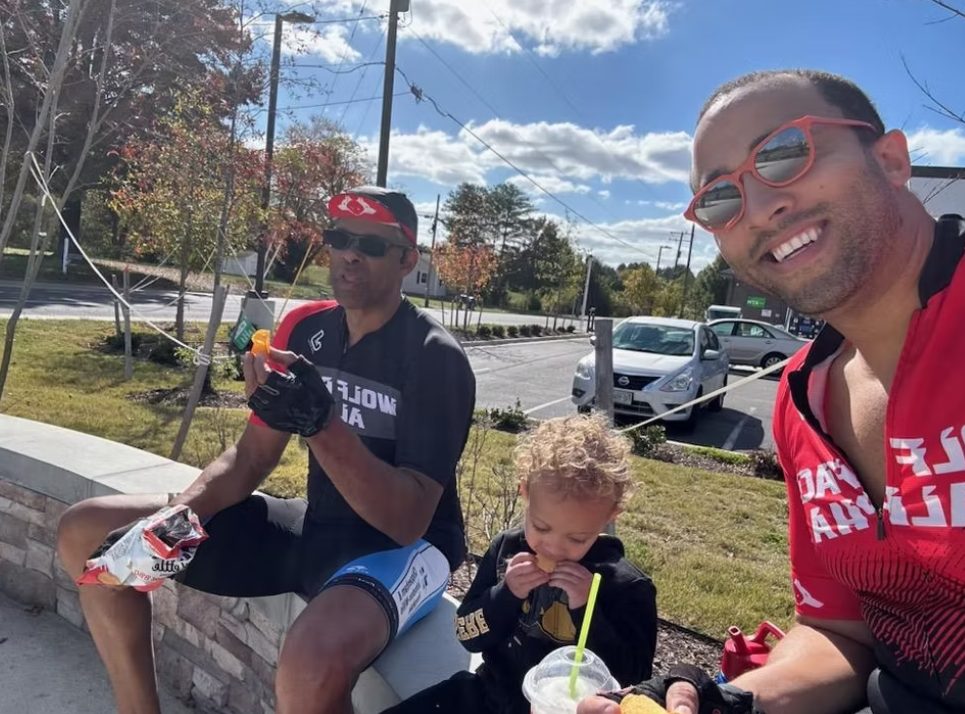 Riders sharing a snack break with a young rider