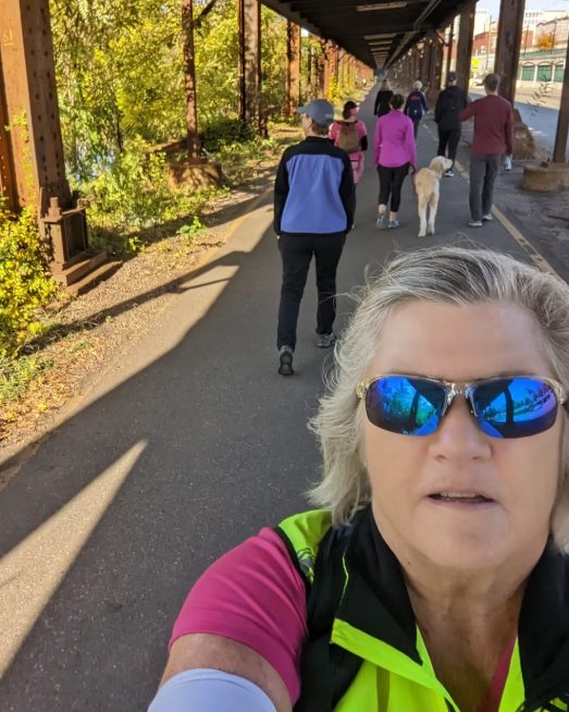 A group of walkers and a dog on the Capital Trail near downtown Richmond